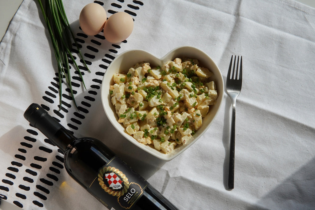 Image showing a bowl of creamy Potato and Egg Salad, garnished with fresh dill and a sprinkle of paprika.