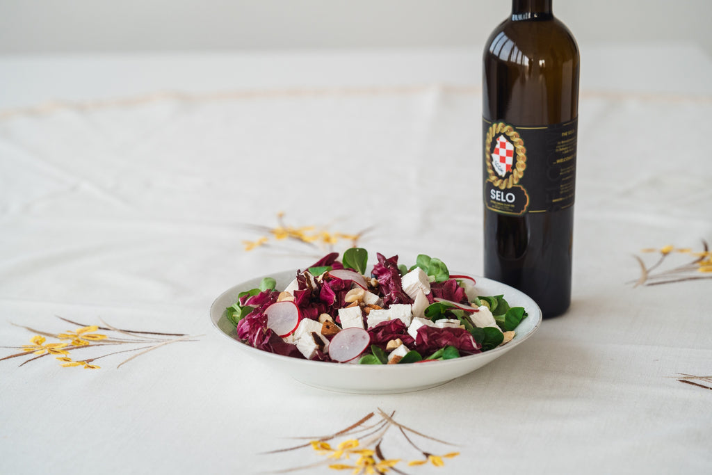 Spring Green Salad with Radishes and Goat Cheese - A colorful salad with mixed greens, sliced radishes, crumbled goat cheese, and sliced almonds, dressed in a tangy vinaigrette.